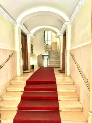 a red carpeted staircase in a building with a red carpet at Rinascita Vatican Home in Rome