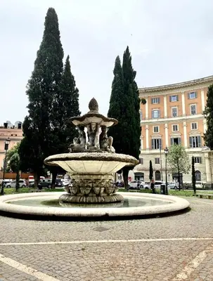 a fountain in the middle of a street at Rinascita Vatican Home in Rome