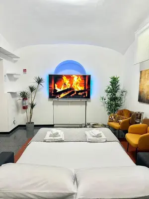 a bedroom with a bed and a tv on a wall at Rinascita Vatican Home in Rome