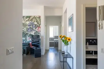 a hallway with a living room with a vase of flowers at Il Cupolone 3 camere a San Pietro in Rome