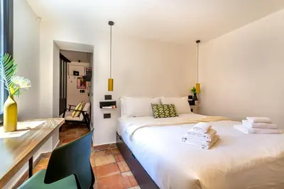 a bedroom with two beds and a desk at iFlat Campo de' Fiori modern apartment in Rome