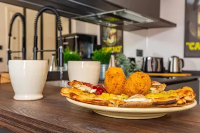 a plate of breakfast food on a table at iFlat Campo de' Fiori modern apartment in Rome