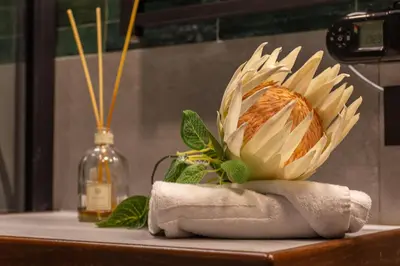 a flower sitting on a towel on a table at iFlat Campo de' Fiori modern apartment in Rome