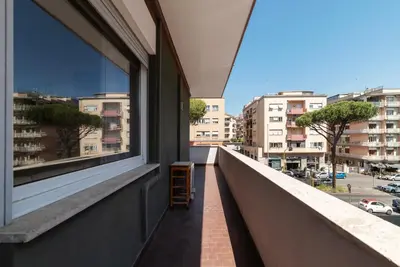 a balcony with a window and a chair on it at GuestHost - Villa Pamphili & Vaticano Cozy Apartment in Rome