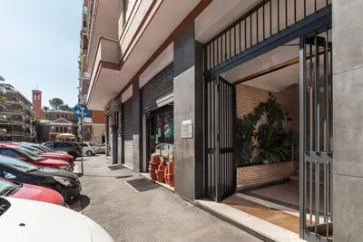 a street with cars parked outside of a store at GuestHost - Villa Pamphili & Vaticano Cozy Apartment in Rome