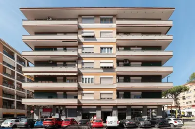 a tall building with cars parked in front of it at GuestHost - Villa Pamphili & Vaticano Cozy Apartment in Rome
