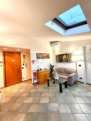 a living room with a couch and a skylight at Attic Garden in Rome