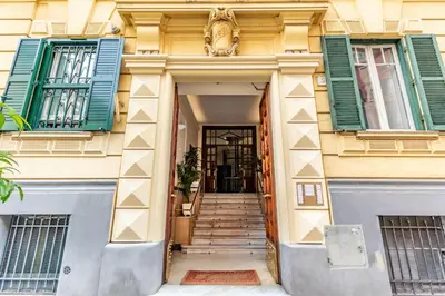 an entrance to a building with green shutters and stairs at Rome As You Feel - Cozy Open Space Near the Vatican in Rome