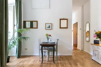 a dining room with a table and chairs at Rome As You Feel - Cozy Open Space Near the Vatican in Rome