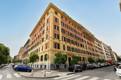 a large building with cars parked in a parking lot at Rome As You Feel - Cozy Open Space Near the Vatican in Rome