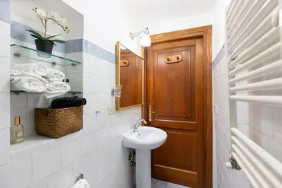 a bathroom with a sink and a mirror at Rome As You Feel - Cozy Open Space Near the Vatican in Rome