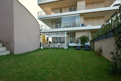 an apartment building with a lawn in front of it at Enchanting Garden Retreat in Rome