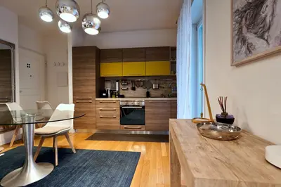 a kitchen with a table and a dining room at Enchanting Garden Retreat in Rome
