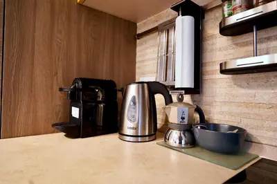 a coffee maker sitting on a counter in a kitchen at Enchanting Garden Retreat in Rome