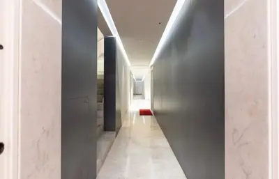 a hallway with a metal wall and a hallway with white walls at Enchanting Garden Retreat in Rome