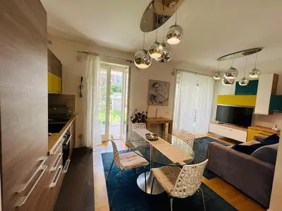 a living room with a couch and a table at Enchanting Garden Retreat in Rome