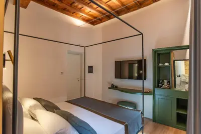 a bedroom with a bed with a large mirror at Ora Acanfora Suites in Rome