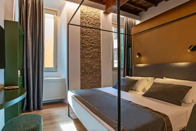 a bedroom with a bed in a room at Ora Acanfora Suites in Rome