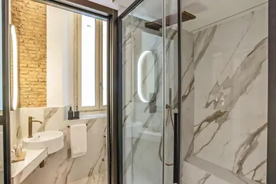 a bathroom with a shower and a sink at Ora Acanfora Suites in Rome