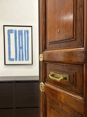 a wooden door in a room with a picture at Cozy apartment- 100 meters from Vatican in Rome