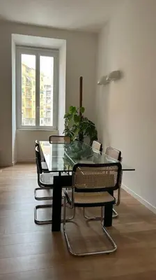 a dining room with a glass table and chairs at Cozy apartment- 100 meters from Vatican in Rome