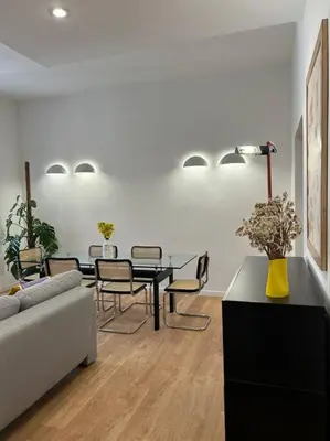 a living room with a couch and a table and chairs at Cozy apartment- 100 meters from Vatican in Rome