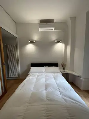 a bedroom with a large white bed in a room at Cozy apartment- 100 meters from Vatican in Rome