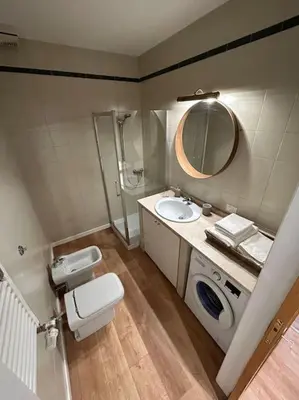 a bathroom with a toilet and a sink and a mirror at Cozy apartment- 100 meters from Vatican in Rome