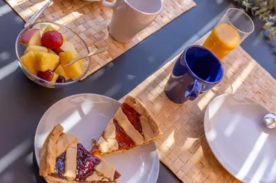 a table with a plate of bread and a bowl of fruit at iFlat Peaceful apt with terrace next to Vatican in Rome
