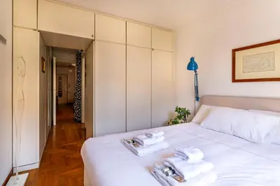 a bedroom with a white bed with towels on it at iFlat Peaceful apt with terrace next to Vatican in Rome