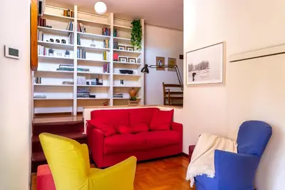 a living room with a red couch and two chairs at iFlat Peaceful apt with terrace next to Vatican in Rome