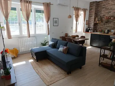 a living room with a blue couch and a table at Think House in Rome