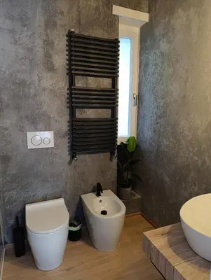 a bathroom with a white toilet and a sink at Think House in Rome
