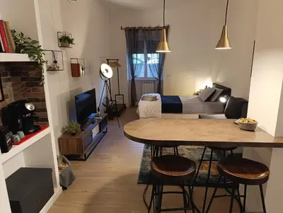 a small living room with a table and a bed at Think House in Rome