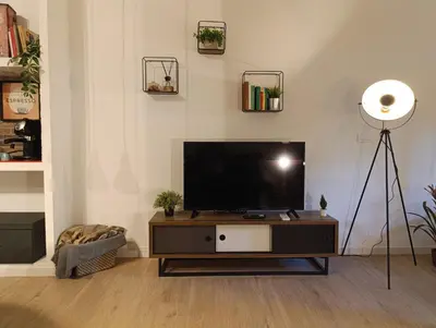 a living room with a flat screen tv on a table at Think House in Rome