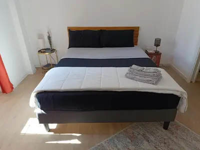a bedroom with a large bed with a blanket at Think House in Rome