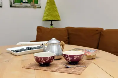a table with two cups and a tea kettle on it at Cappellari37 in Rome