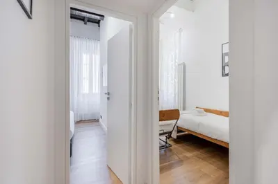 a white room with a bedroom and a bed at Rufina's Home in Rome
