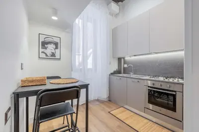 a kitchen with a table and a sink and a stove at Rufina's Home in Rome