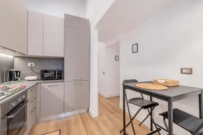 a kitchen with a table and a counter top at Rufina's Home in Rome