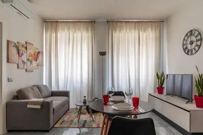 a living room with a couch and a table at GuestHost - Regina Margherita Suite in Rome