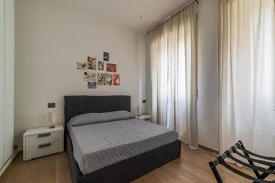 a bedroom with a bed and a chair at GuestHost - Regina Margherita Suite in Rome
