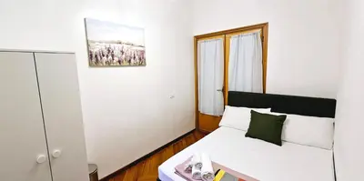 a small bedroom with a bed and a window at VATICAN ERA Guest House in Rome