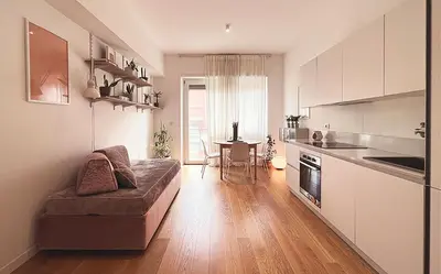 a living room with a couch and a kitchen with a table at Baldo Design Apartment - Rome - MA - Vatican in Rome