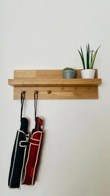a wooden shelf with three baseball bats hanging on a wall at Baldo Design Apartment - Rome - MA - Vatican in Rome