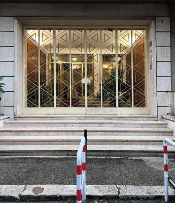 a building with a large window and stairs in front at Baldo Design Apartment - Rome - MA - Vatican in Rome