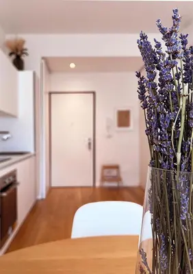 a vase filled with purple flowers sitting on a table at Baldo Design Apartment - Rome - MA - Vatican in Rome