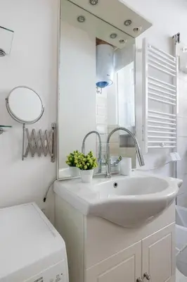 a white bathroom with a sink and a mirror at CASA ELENA, Testaccio in Rome