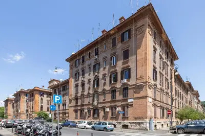 a large brick building on a city street with parked motorcycles at CASA ELENA, Testaccio in Rome