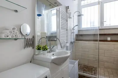 a white bathroom with a sink and a mirror at CASA ELENA, Testaccio in Rome